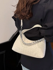 Chic off-white woven hobo bag with bold silver chain and adjustable shoulder strap
