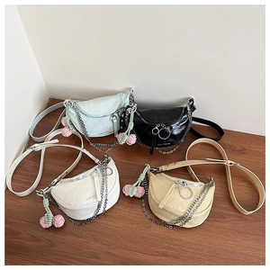 Collection of quilted crescent crossbody bags in pastel tones with chain straps