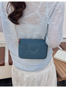 Vintage washed denim crossbody bag featuring heart embroidery and metal chain strap