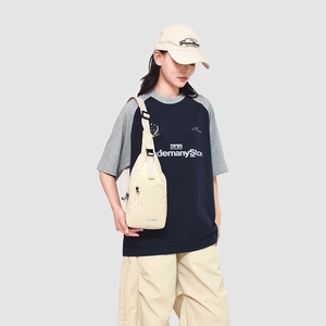 Sac de poitrine minimaliste en nylon crème pour hommes avec sangle réglable porté par mannequin