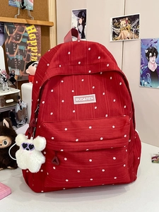 Red floral pattern canvas backpack for students with a cute white plush bear keychain