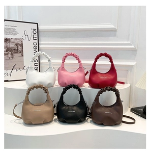 Details of minimalist crescent bags in six colors with ruched handles and crossbody straps