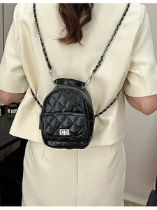 Mini black quilted leather backpack with metal chain straps and turn-lock closure