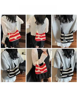 Detail view of striped knit tote bag with logo patch showing multiple carrying styles