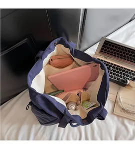 Interior view of navy blue canvas tote bag showing spacious compartments for gadgets