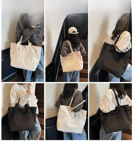 Detail view of large canvas tote bag with side drawstring pocket and metal ring handle