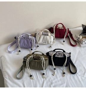 Collection of nylon drawstring bucket bags in five colors with wide shoulder straps