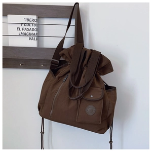 Macro detail of dark brown nylon drawstring backpack with durable straps and side pockets