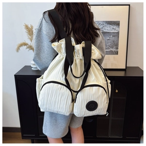 Detailed back view of a white drawstring backpack with dual zip pockets and nylon texture