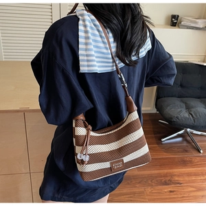 Detail of striped knit shoulder bag with leather drawstring and CHIO '2ND logo plaque