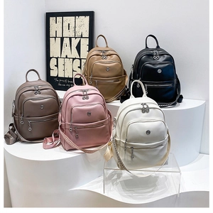 Five PU leather backpacks in black, white, pink, brown, khaki colors on display stands