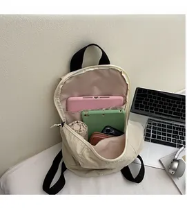 Detailed view of the large capacity interior of a beige backpack showing storage space
