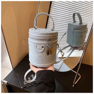 Détail du sac seau strass bleu clair montrant le charme cadenas et le double zip