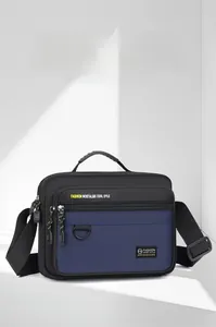 Detailed front view of navy blue oxford shoulder bag with zipper and metal D-ring