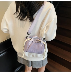 Detailed view of lavender drawstring bucket bag with decorative cord and woven strap