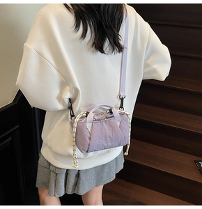 Detail view of light purple drawstring bucket bag showing adjustable strap and knot detail