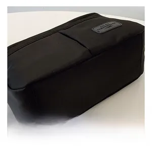 Detail view of the black fabric inner organizer with multiple compartments and logo patch