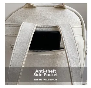 Detail showing back anti-theft zipper pocket on beige faux leather backpack with phone