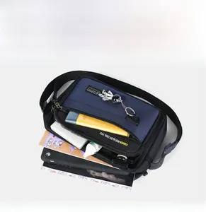 Detail of multi-pocket navy oxford bag showing spacious interior with laptop storage