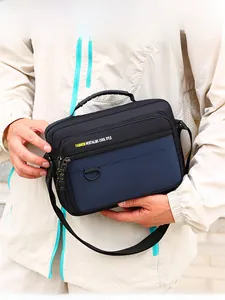 Men's casual crossbody bag detail showing multi-layer design and adjustable strap on model