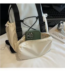 Front zipper pocket of cream outdoor backpack holding a smartphone for storage capacity