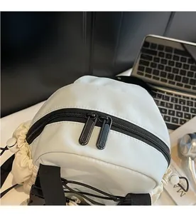 Detailed close-up of smooth dual black metal zippers on a beige waterproof nylon backpack