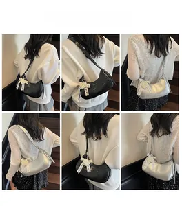 Crescent shoulder bags in black and silver shown with model for size and fit
