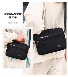 Detail of black oxford fabric shoulder bag with multi-layer zippers and top handle strap