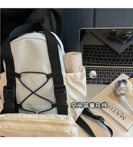 Detail of multi-pocket off-white backpack showing side pocket for folding umbrella