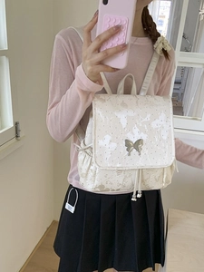 Chic beige glitter backpack with butterfly patterns and silver butterfly clasp closure