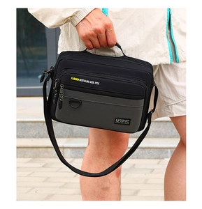 Detail of high-density waterproof oxford fabric and layered zipper pockets on messenger bag
