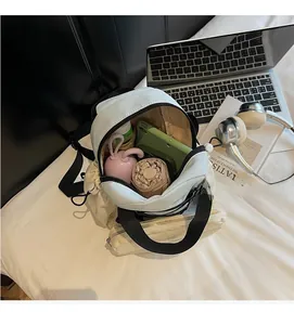 Interior view of light beige canvas backpack showing large capacity and daily essentials