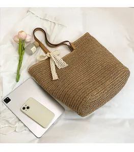 Handwoven straw tote bag size comparison with iPad showing large capacity for beach travel