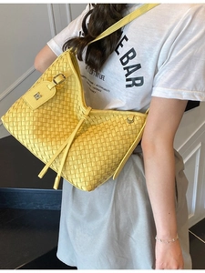 Bright yellow woven shoulder bag for women featuring a stylish metal letter M tag pendant