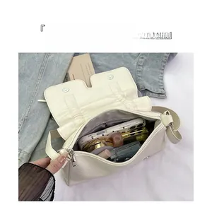 Interior view of soft beige crossbody bag showing ample storage for phone and makeup