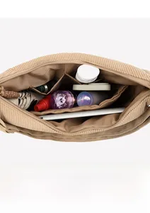 Interior view of khaki corduroy shoulder bag showing spacious storage and compartments