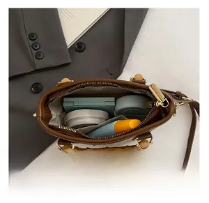 Interior view showing the large capacity of a brown vintage bag with gold zipper