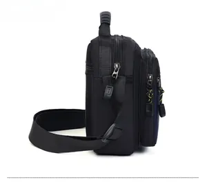 Side view of multi-compartment Oxford cloth crossbody bag with reinforced top handle