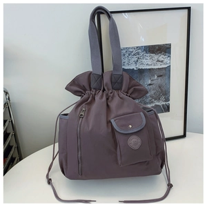 Detail view of purple drawstring tote bag with smooth texture and side zipper pocket