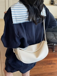 White crescent leather crossbody bag for women with adjustable strap and gold metal hardware