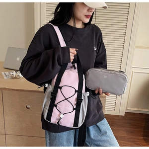 Detail of pink and grey waterproof crossbody bag set with adjustable straps and buckles