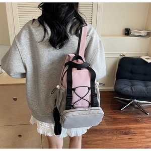 Detailed back view of pink and grey contrast backpack with functional bungee cords