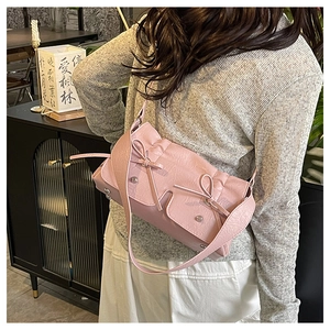 Pink shoulder bag featuring pleated texture and charming double pockets with bow details