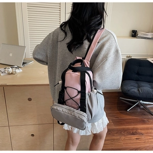 Pink and gray contrast backpack with multiple pockets and waterproof nylon material