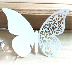 Detail of laser-cut butterfly place card for wine glasses in white paper finish