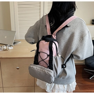 Pink and grey nylon backpack with drawstring side pockets and small zip coin purse
