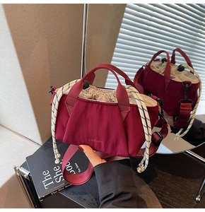 Close-up of burgundy drawstring bucket bag with woven rope detail and shoulder strap