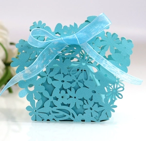 Detailed laser-cut floral pattern on blue wedding gift box with ribbon bow