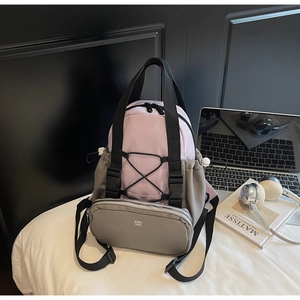 Detail of lavender and gray nylon backpack with KMD 2ND logo and black elastic cords