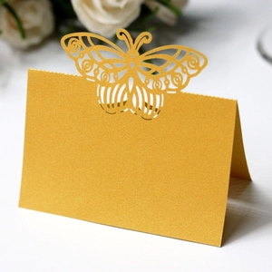 Detailed laser-cut golden butterfly place card with a pearlescent finish for weddings